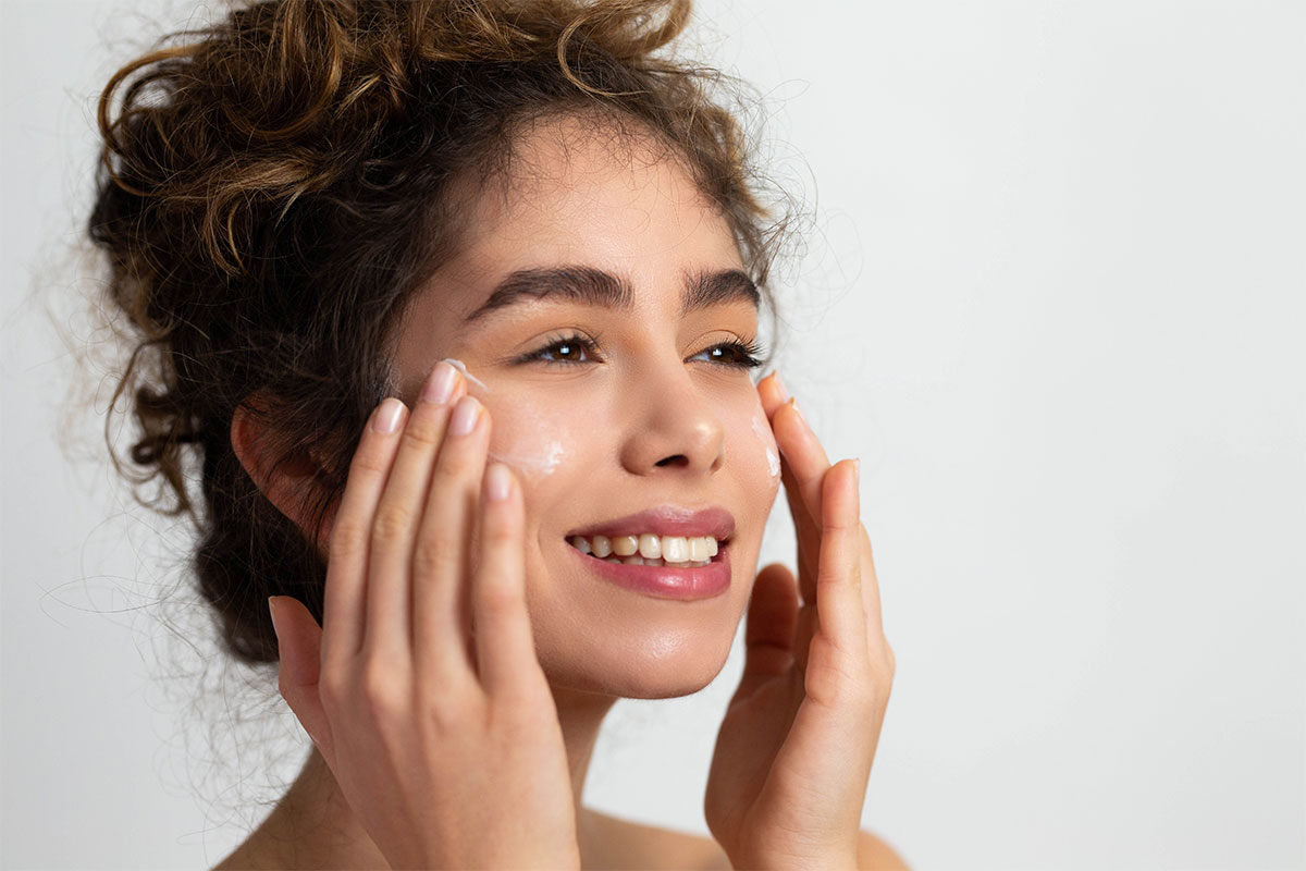 woman cleaning face with medical grade skincare in Scottsdale.